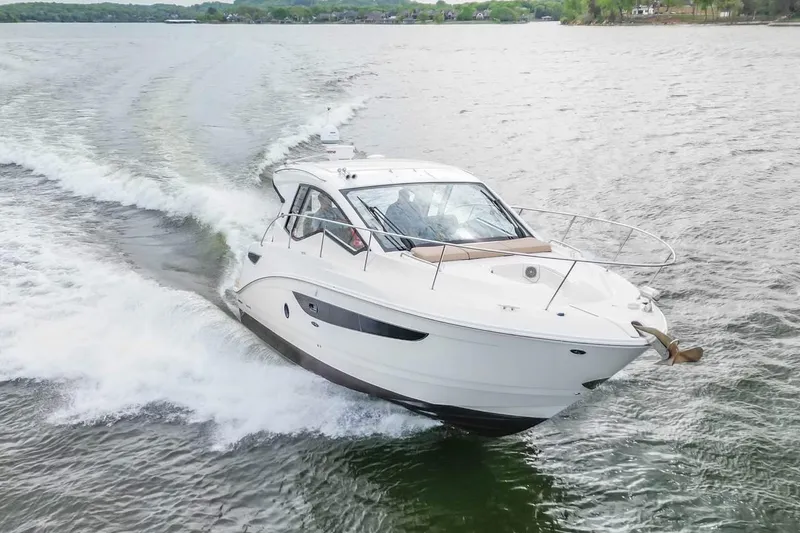 Slide: The Image of 2017 Sea Ray Sundancer 350 Coupe cruising on a lake, creating a wake. - 16