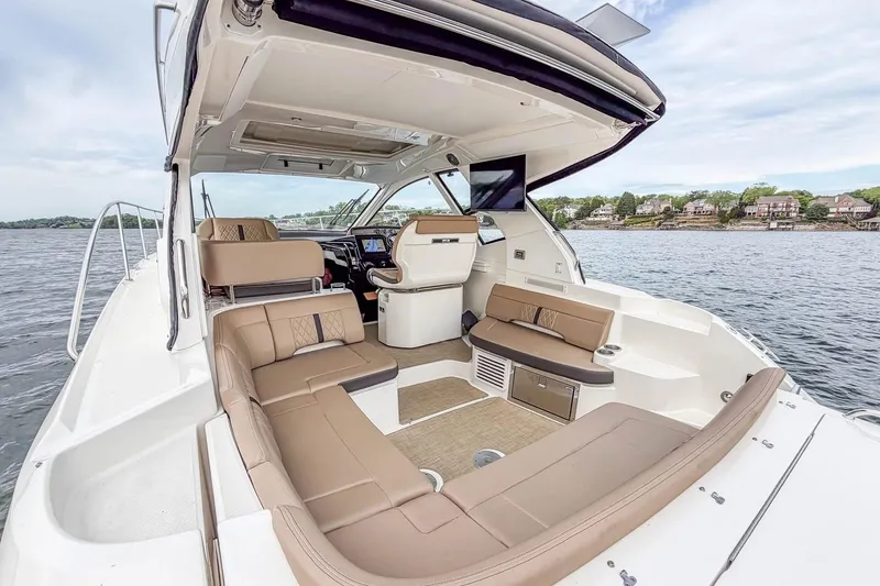 Slide: The Image of 2017 Sea Ray Sundancer 350 Coupe interior with luxurious seating and scenic water view. - 18