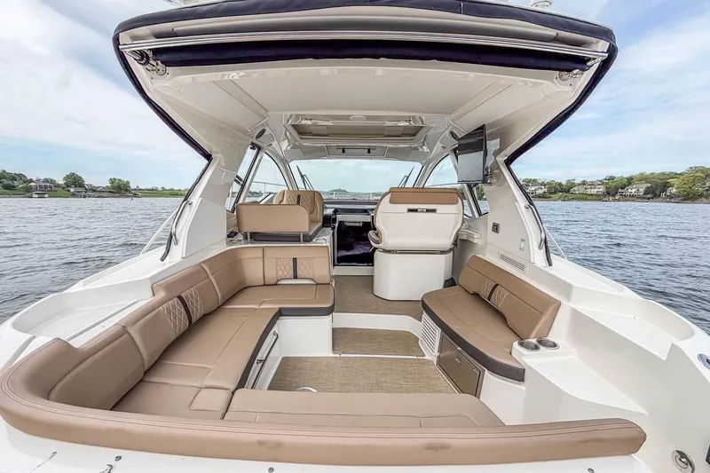 Slide: The Image of 2017 Sea Ray Sundancer 350 Coupe interior with spacious seating on calm waters. - 19