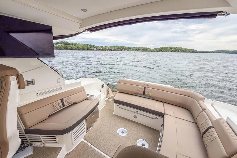 Slide: The Image of Luxurious 2017 Sea Ray Sundancer 350 Coupe yacht interior with elegant seating and scenic water view. - 21