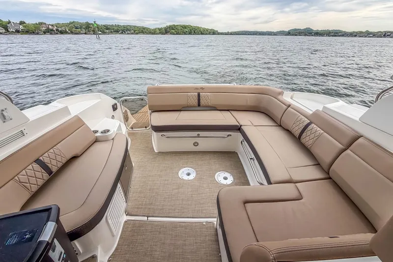 Slide: The Image of 2017 Sea Ray Sundancer 350 Coupe with spacious seating on a serene lake. - 22