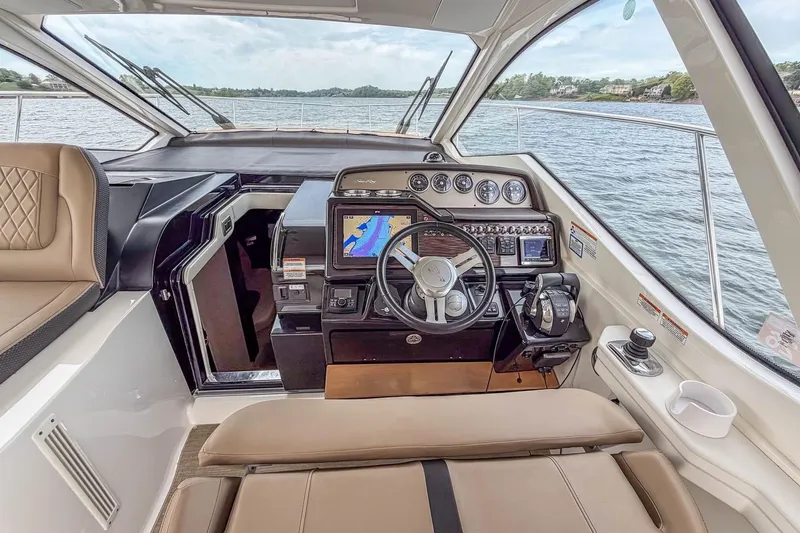 Slide: The Image of 2017 Sea Ray Sundancer 350 Coupe cockpit with modern navigation system and luxurious seating. - 25