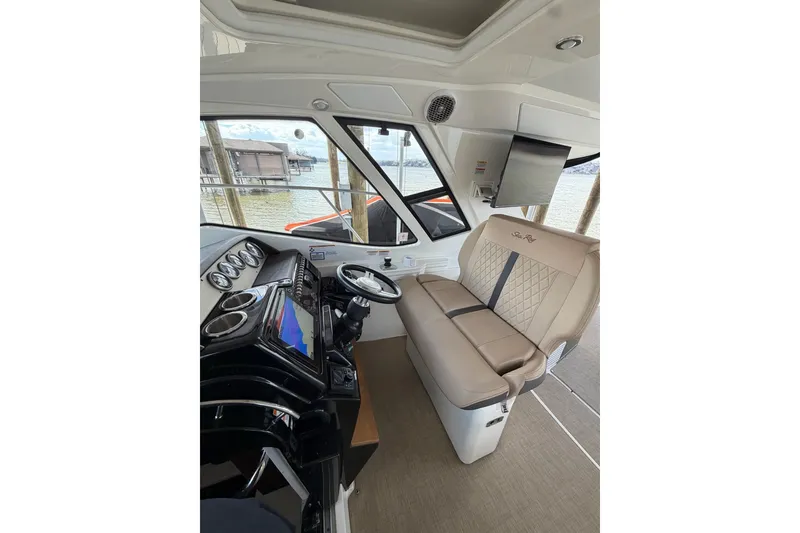 Slide: The Image of Interior of 2017 Sea Ray Sundancer 350 Coupe with helm and seating area. - 3