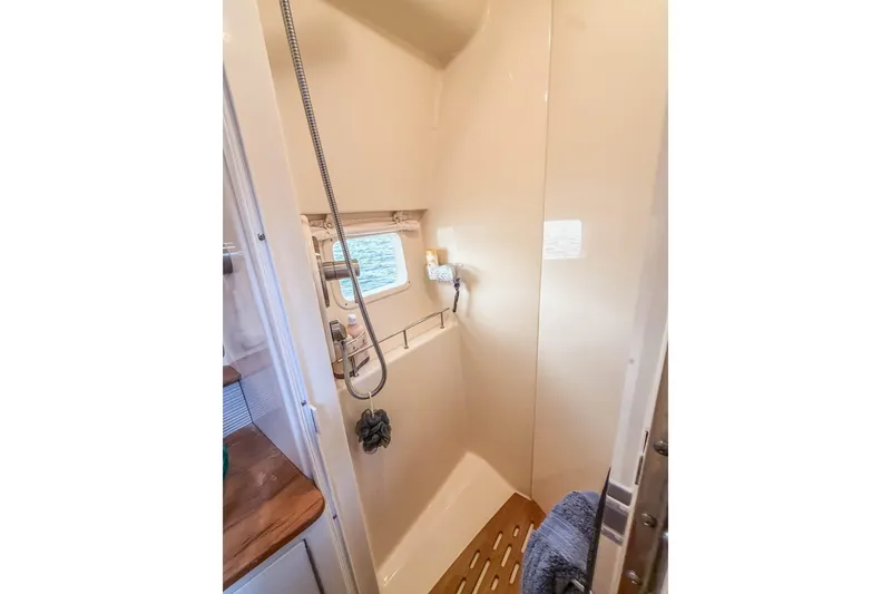 Slide: The Image of Shower area in 2017 Sea Ray Sundancer 350 Coupe yacht with window and wooden floor mat. - 33