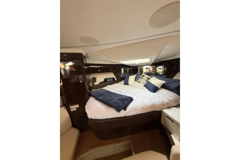 Slide: The Image of Luxurious cabin interior of 2017 Sea Ray Sundancer 350 Coupe with plush bedding. - 8