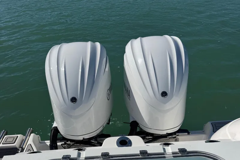 Slide: The Image of 2021 Sea Fox 288 Commander boat with dual outboard engines on water. - 14