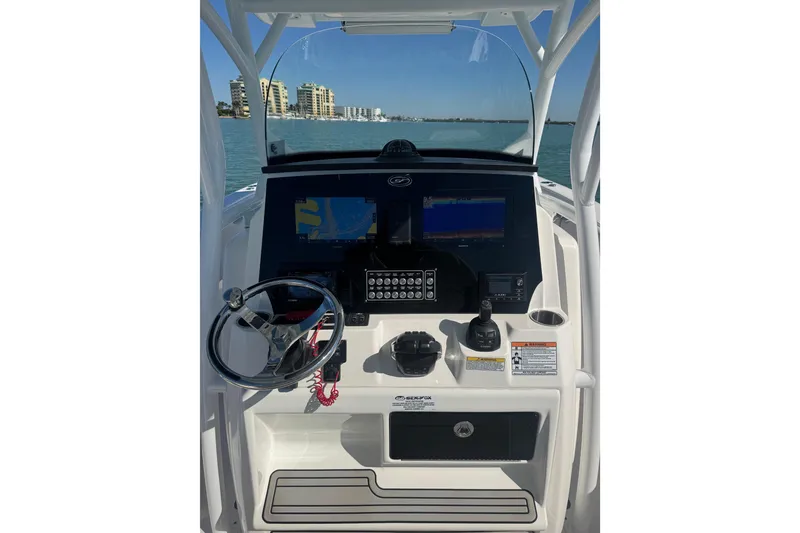 Slide: The Image of 2021 Sea Fox 288 Commander boat dashboard with navigation screens and controls. - 21