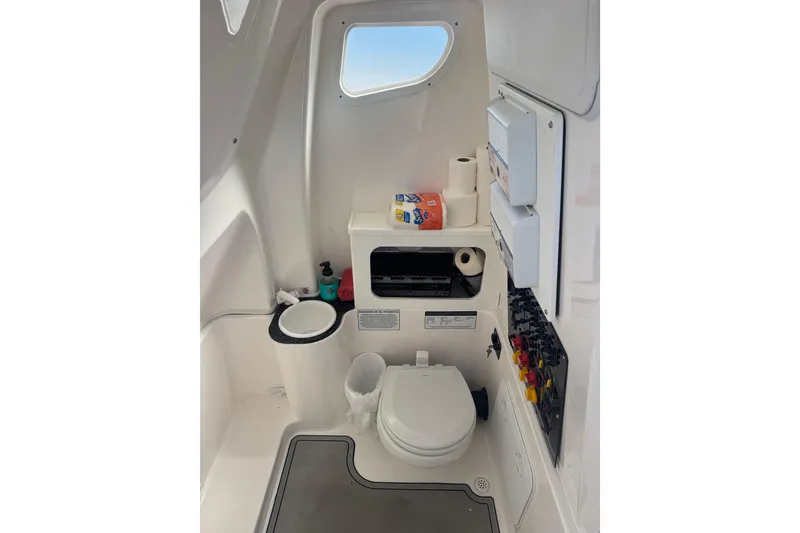 Slide: The Image of Interior of 2021 Sea Fox 288 Commander boat bathroom with toilet and storage. - 22