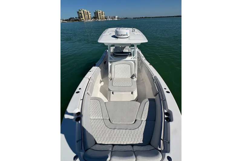 Slide: The Image of 2021 Sea Fox 288 Commander boat on calm water, featuring spacious seating and Garmin equipment. - 25