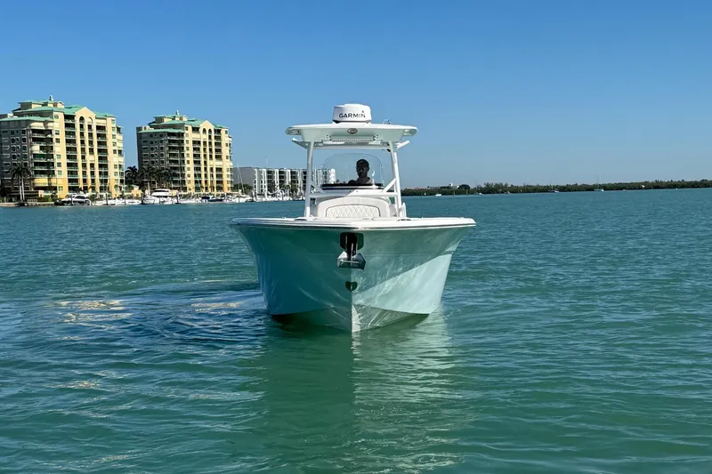 Slide: The Image of 2021 Sea Fox 288 Commander boat cruising on calm water near coastal buildings. - 29
