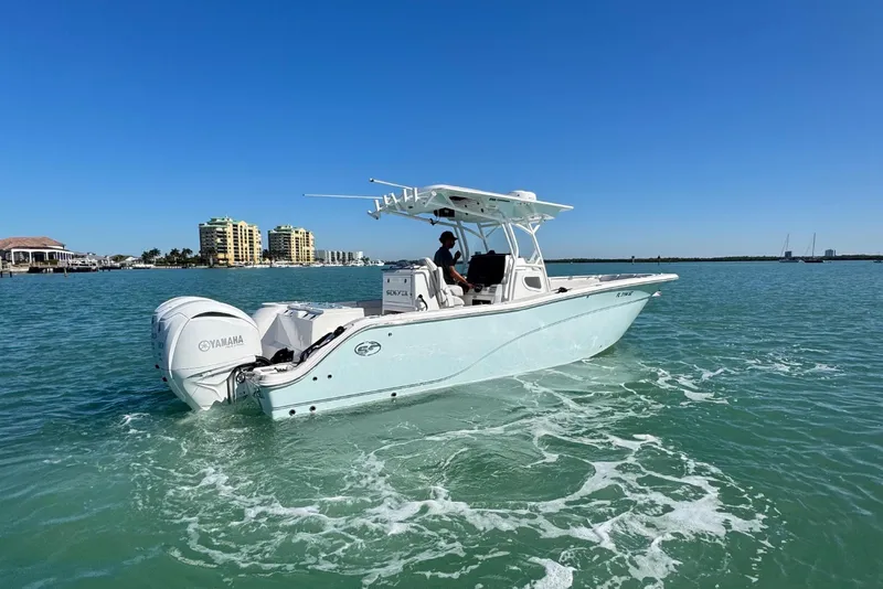 Slide: The Image of 2021 Sea Fox 288 Commander boat cruising on clear blue water under a sunny sky. - 32