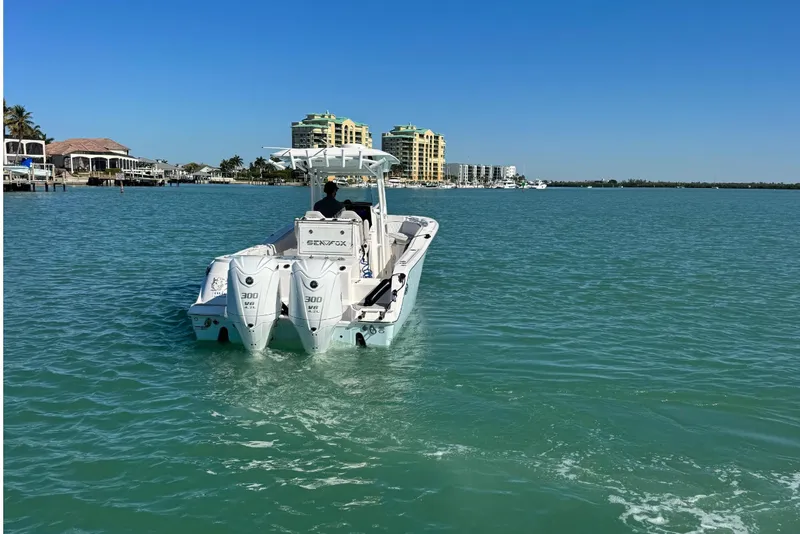 Slide: The Image of Sea Fox 288 Commander 2021 on calm waters near coastal buildings. - 6