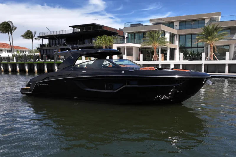 The Image of 2022 Cruisers Yachts 38 GLS OB in water near luxury waterfront homes. - 0