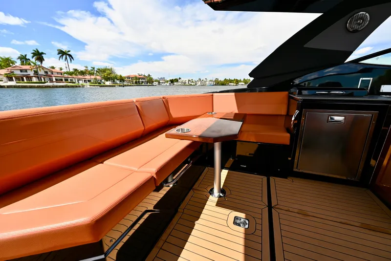 Slide: The Image of Luxurious seating area on 2022 Cruisers Yachts 38 GLS OB, with waterfront view. - 11