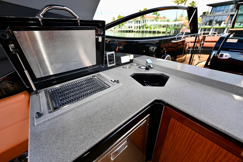 Slide: The Image of Outdoor kitchen on 2022 Cruisers Yachts 38 GLS OB with grill and sink. - 13