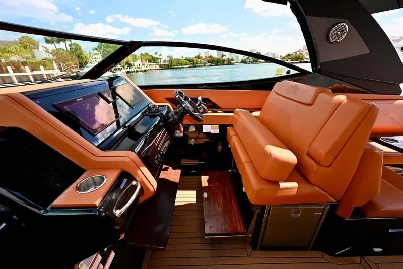 Slide: The Image of Luxurious 2022 Cruisers Yachts 38 GLS OB helm with leather seating and modern controls. - 15