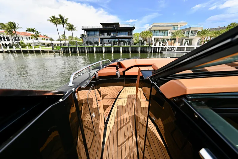 Slide: The Image of 2022 Cruisers Yachts 38 GLS OB on water, luxury waterfront homes in background. - 22
