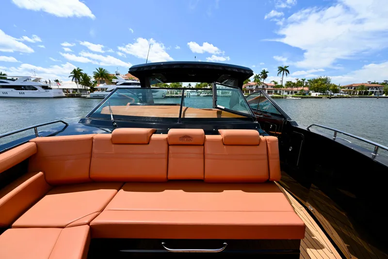 Slide: The Image of 2022 Cruisers Yachts 38 GLS OB with luxurious seating on a sunny waterfront. - 25
