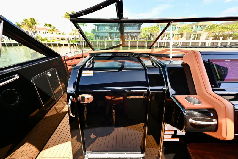 Slide: The Image of 2022 Cruisers Yachts 38 GLS OB helm with modern controls and waterfront view. - 27