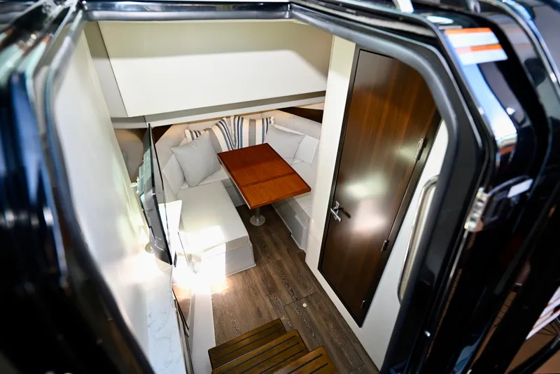 Slide: The Image of Interior of 2022 Cruisers Yachts 38 GLS OB, featuring cozy seating and wooden table. - 28