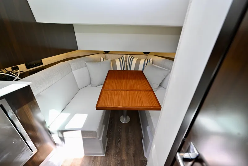 Slide: The Image of 2022 Cruisers Yachts 38 GLS OB interior with cozy seating and wooden table. - 29