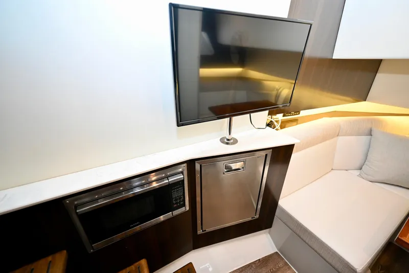 Slide: The Image of Interior of 2022 Cruisers Yachts 38 GLS OB with TV, microwave, and seating area. - 30