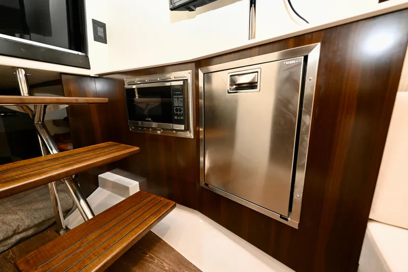 Slide: The Image of 2022 Cruisers Yachts 38 GLS OB interior with microwave and stainless steel appliance. - 31