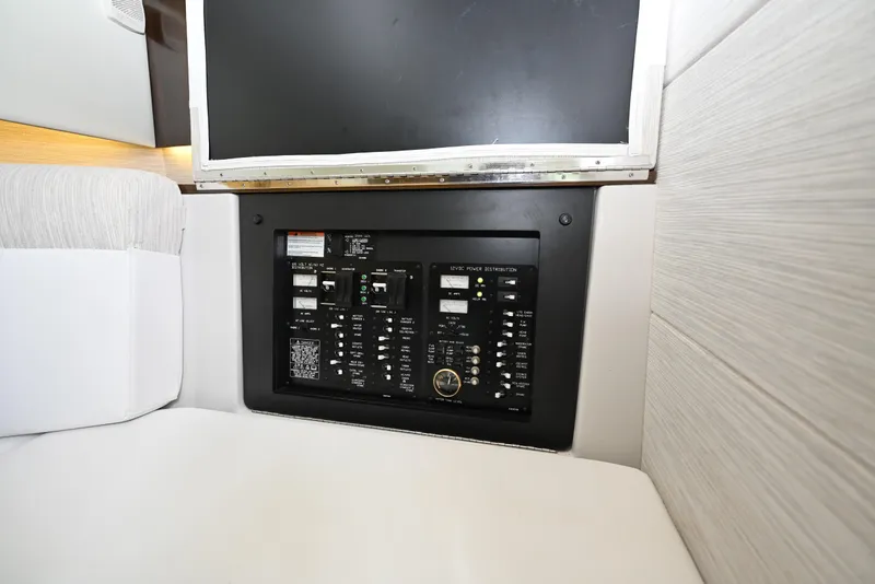Slide: The Image of Electrical panel inside 2022 Cruisers Yachts 38 GLS OB, featuring control switches and indicators. - 34