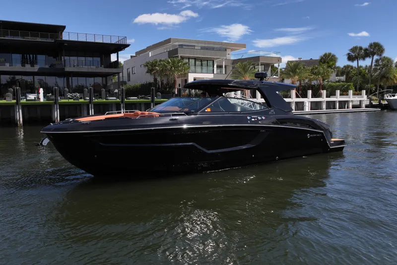 Slide: The Image of 2022 Cruisers Yachts 38 GLS OB in water near modern waterfront homes. - 42