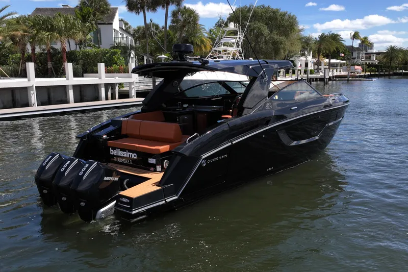 Slide: The Image of 2022 Cruisers Yachts 38 GLS OB in a scenic waterfront setting. - 43