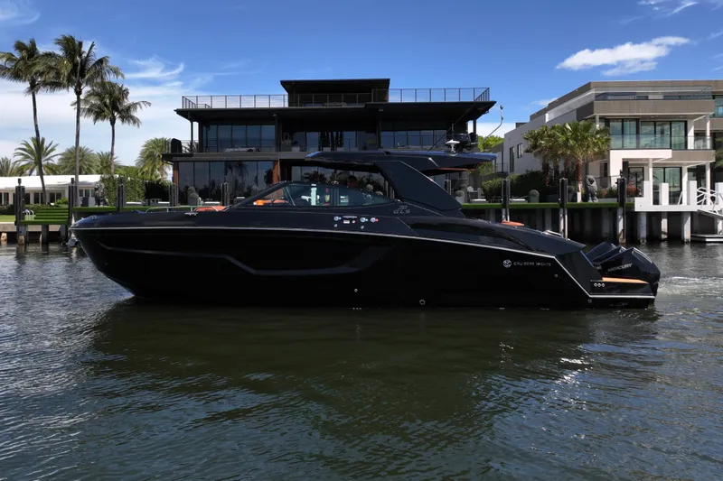 Slide: The Image of 2022 Cruisers Yachts 38 GLS OB on water, modern waterfront homes in background. - 44