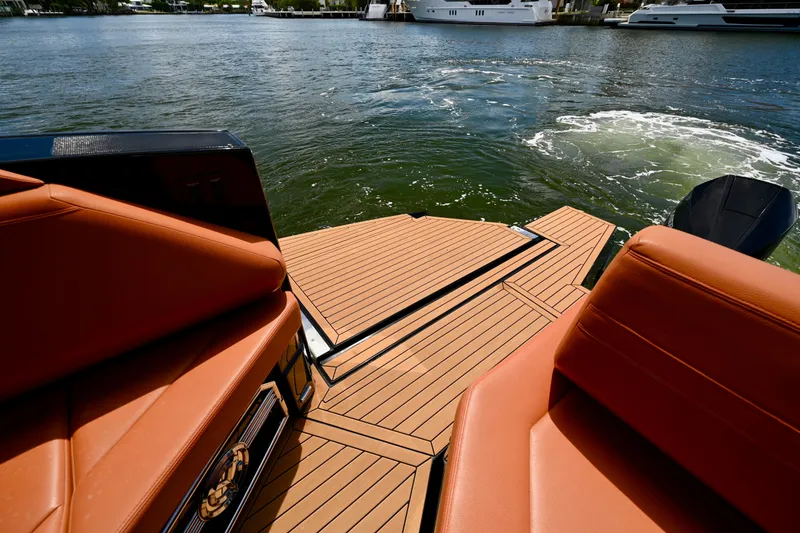 Slide: The Image of 2022 Cruisers Yachts 38 GLS OB with luxurious seating and swim platform on the water. - 8