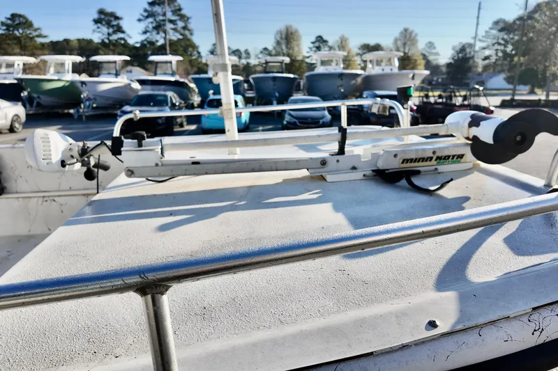 Slide: The Image of 2009 Carolina Skiff 18 DLX with Minn Kota trolling motor in a boatyard. - 10