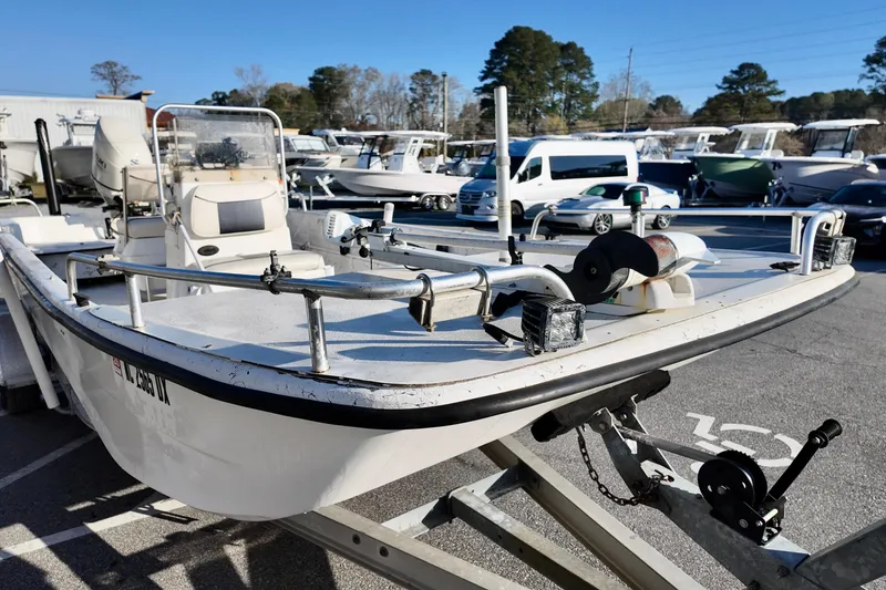 Slide: The Image of 2009 Carolina Skiff 18 DLX boat on trailer in a marina parking lot. - 11