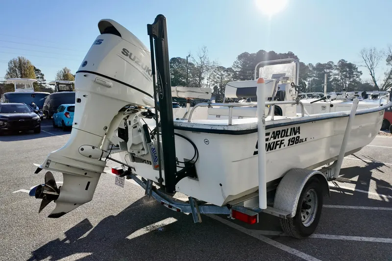 Slide: The Image of 2009 Carolina Skiff 18 DLX boat on trailer with Suzuki outboard motor. - 14