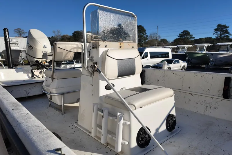 Slide: The Image of 2009 Carolina Skiff 18 DLX boat interior with seating and console, parked outdoors. - 8