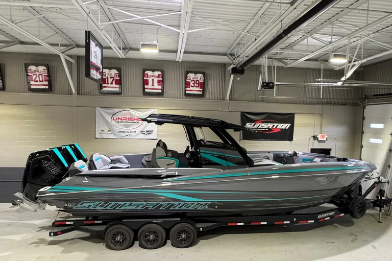The Image of 2026 Sunsation 34 CCX boat in showroom, sleek design with vibrant accents. - 0