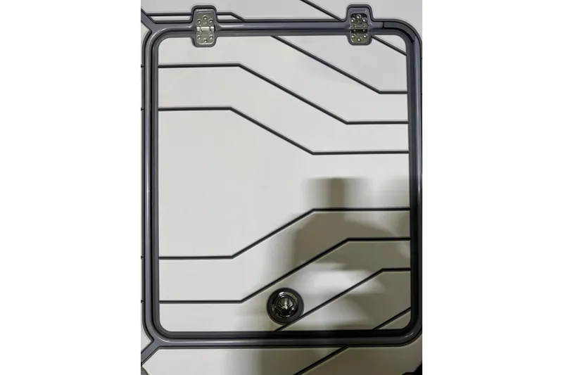 Slide: The Image of 2026 Sunsation 34 CCX boat hatch with geometric pattern and secure latch. - 10