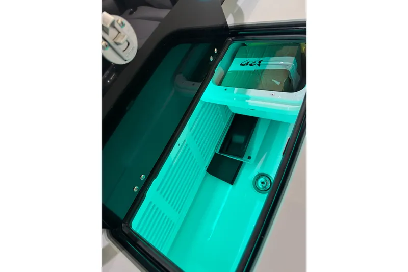 Slide: The Image of Interior view of 2026 Sunsation 34 CCX boat compartment with teal lighting. - 14