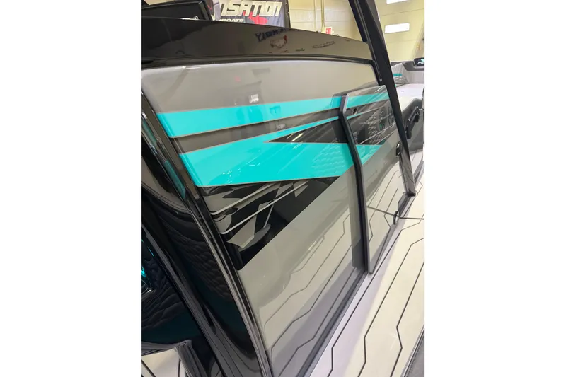 Slide: The Image of 2026 Sunsation 34 CCX boat with sleek turquoise and black design accents. - 23