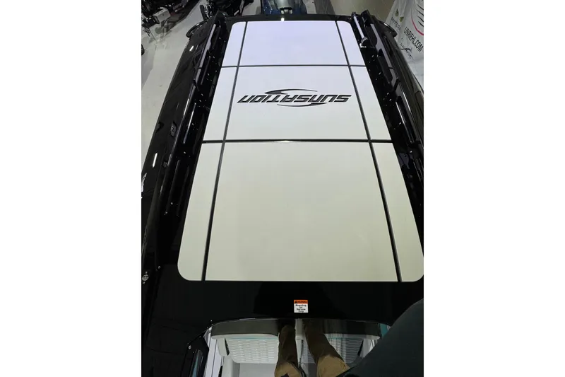 Slide: The Image of 2026 Sunsation 34 CCX boat deck with logo, viewed from above in showroom. - 31