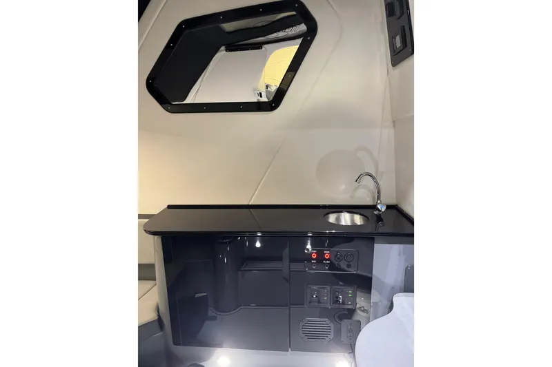 Slide: The Image of Interior of 2026 Sunsation 34 CCX boat featuring sleek kitchenette with sink and controls. - 35