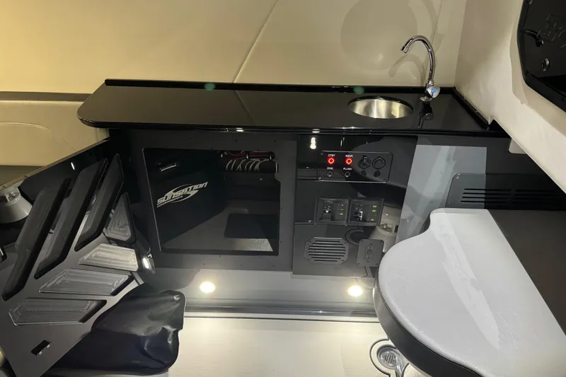 Slide: The Image of Interior of 2026 Sunsation 34 CCX boat with sleek black countertop and modern controls. - 36