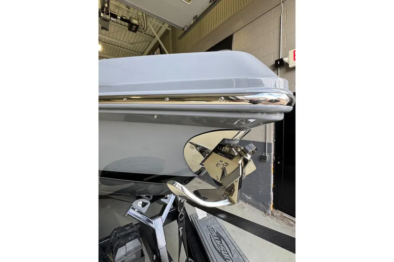 Slide: The Image of 2026 Sunsation 34 CCX boat with polished chrome anchor in a garage setting. - 7