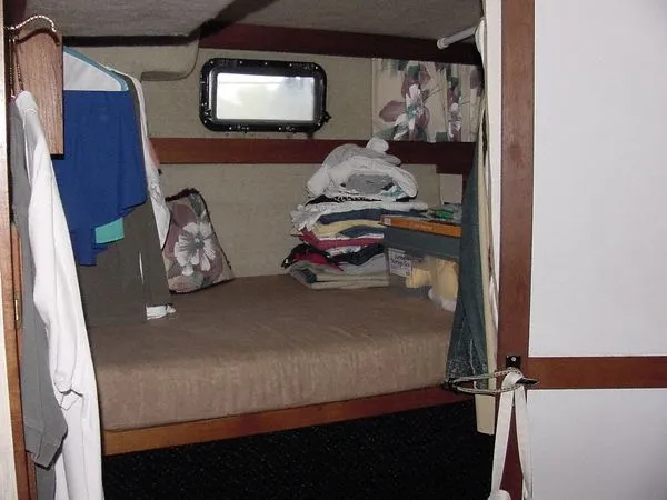 Slide: The Image of Interior of 1985 Carver 3207 Yacht with bed and clothes. - 10