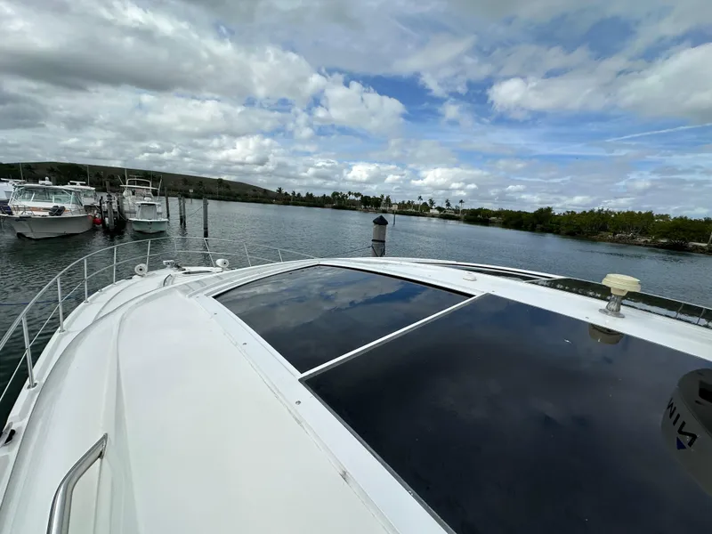 Slide: The Image of 2010 Sea Ray 470 Sundancer yacht docked in a scenic marina. - 13