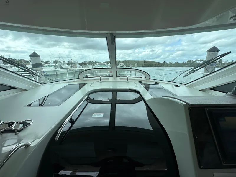 Slide: The Image of 2010 Sea Ray 470 Sundancer yacht interior view with marina backdrop. - 21