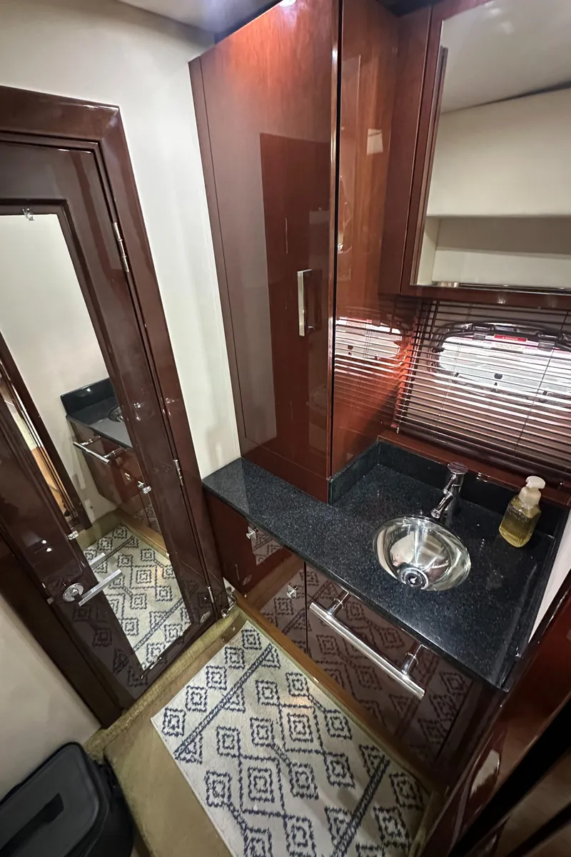 Slide: The Image of Luxurious 2010 Sea Ray 470 Sundancer bathroom with sleek cabinetry and modern fixtures. - 23