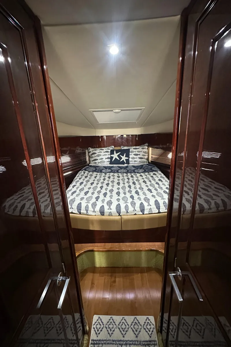 Slide: The Image of Luxurious cabin interior of 2010 Sea Ray 470 Sundancer yacht with elegant bedding. - 27