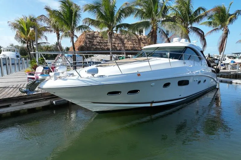 Slide: The Image of 2010 Sea Ray 470 Sundancer yacht docked near palm trees in a marina. - 3